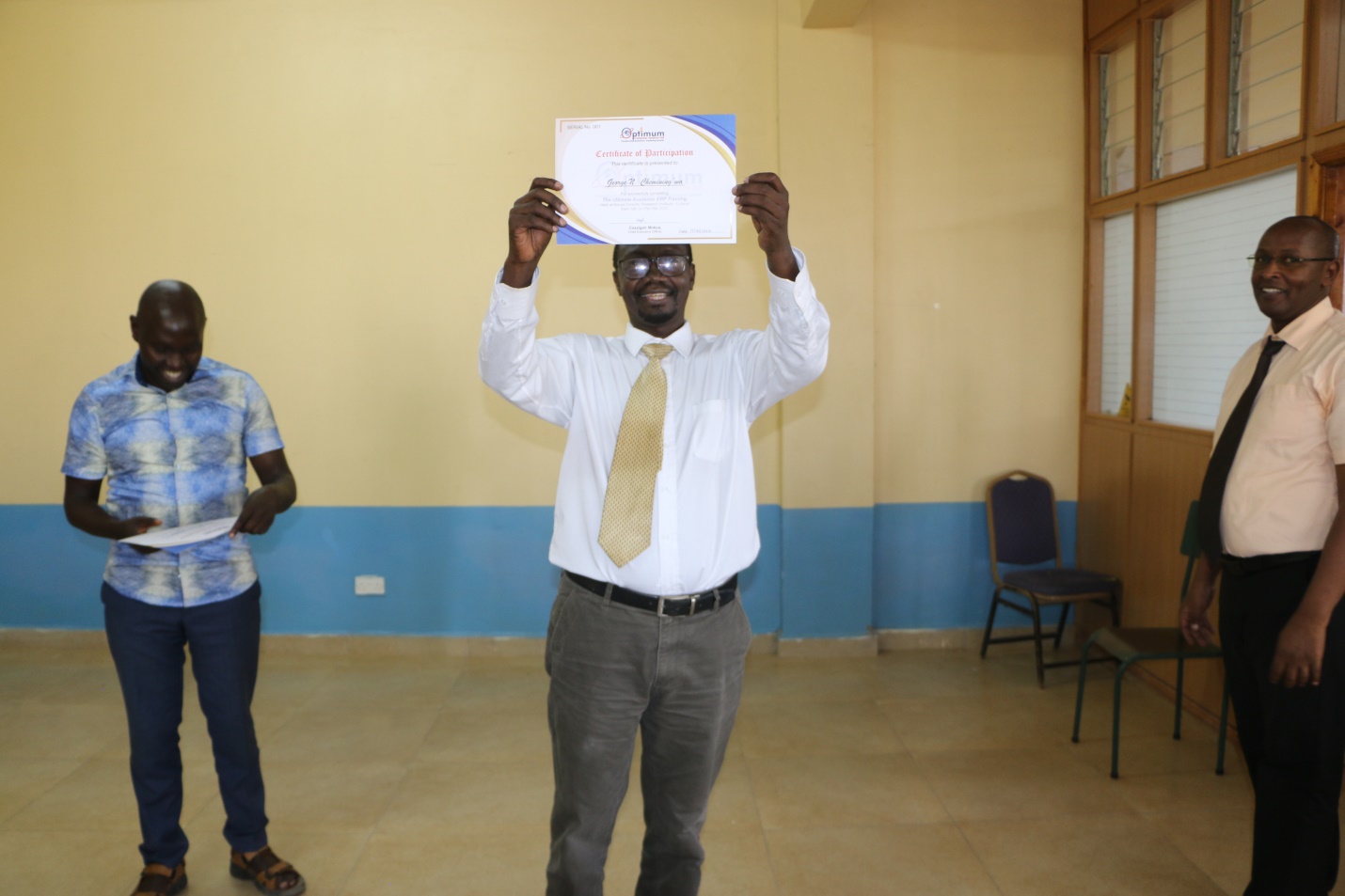 Turkana University College Principal Prof. George Chemining'wa receives his certificate after the training