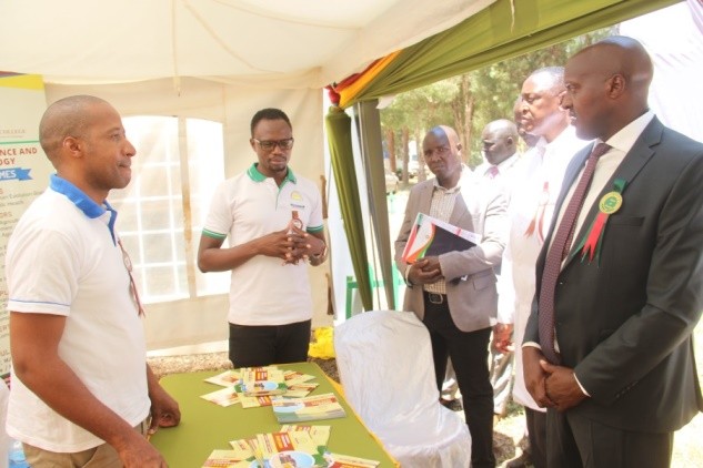 CPA Julius Rutto, Member of Parliament for Kesses Constituency (standing on the right), pays a courtesy visit to the TUC exhibition stand