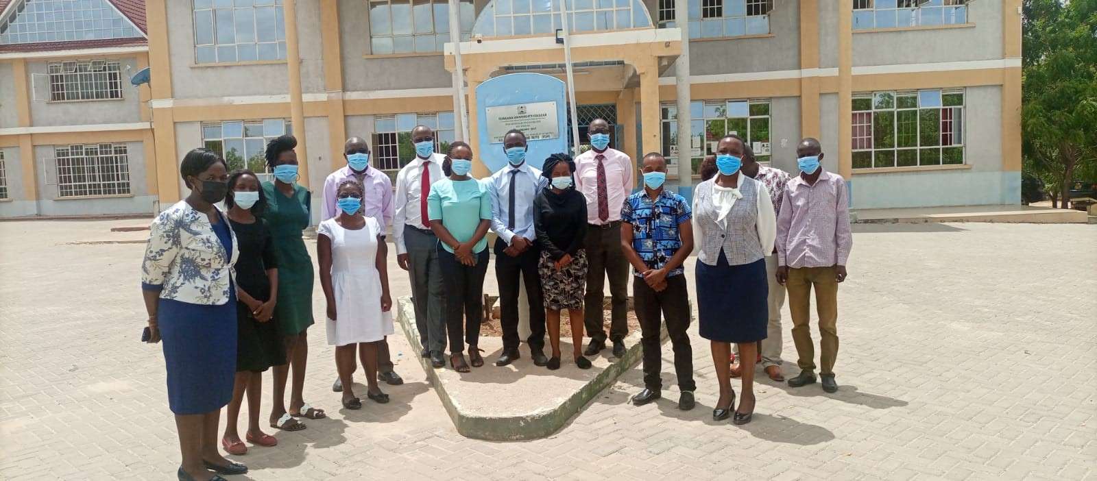 Staff gathered outside the main College building